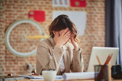 woman with anxiety working at her desk