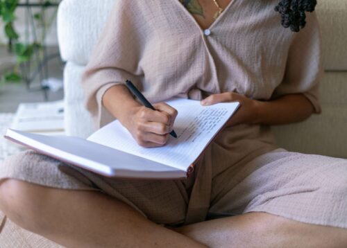 woman at home journaling to help her mental health