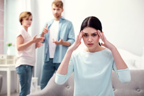 stressed woman surrounded by her toxic family_needs family counseling